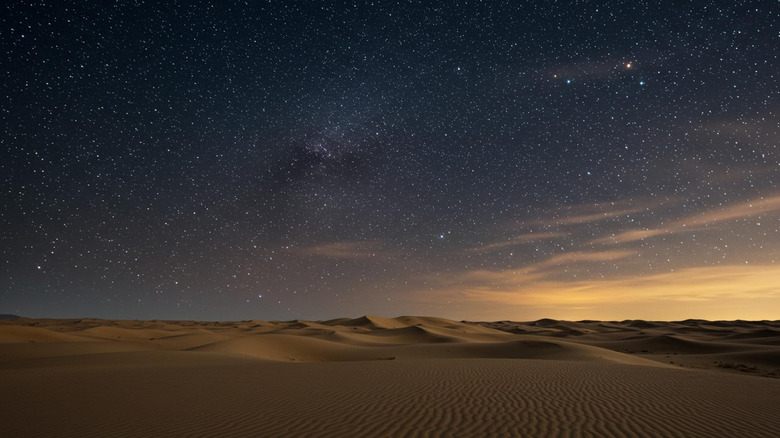 A starry sky stretches over the Mojave's sand dunes