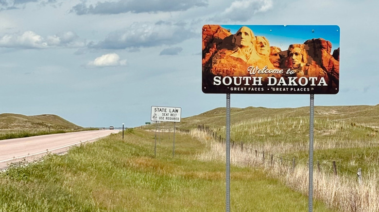 A welcome to South Dakota road sign on the side of the highway