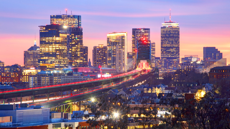 Boston city skyline at dusk showing long exposure view of cars on the highway