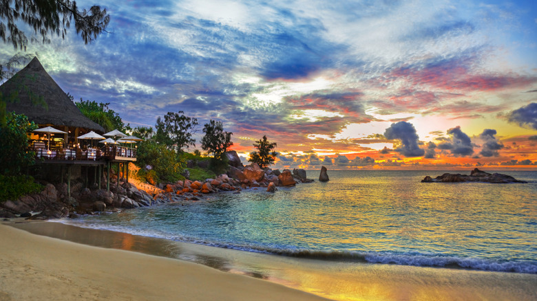 Cafe overlooking tropical beach at sunset