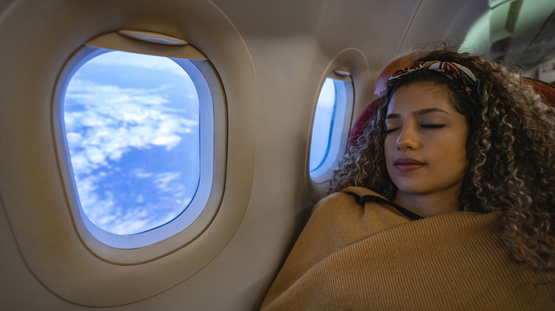 woman sleeping on airplane