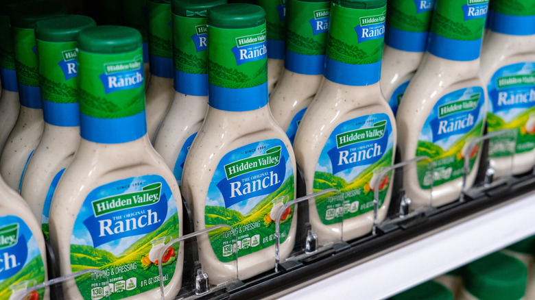 A supermarket shelf of ranch dressing bottles.