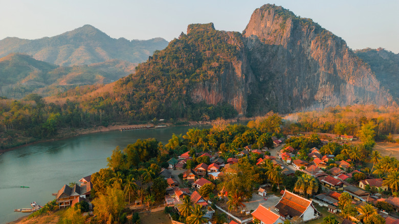 Aerial view of Luang Prabang town, mountains, and the Mekong river.