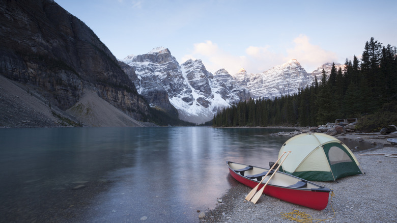 A canoe and tent next to a lake in Banff.