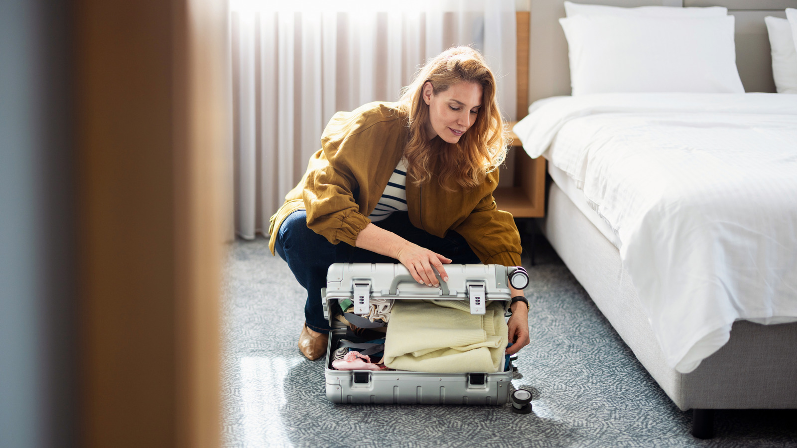 The Unsettling Reason You Should Never Leave Luggage On Hotel Room Floors


