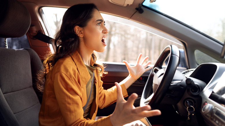 An angry woman driving.
