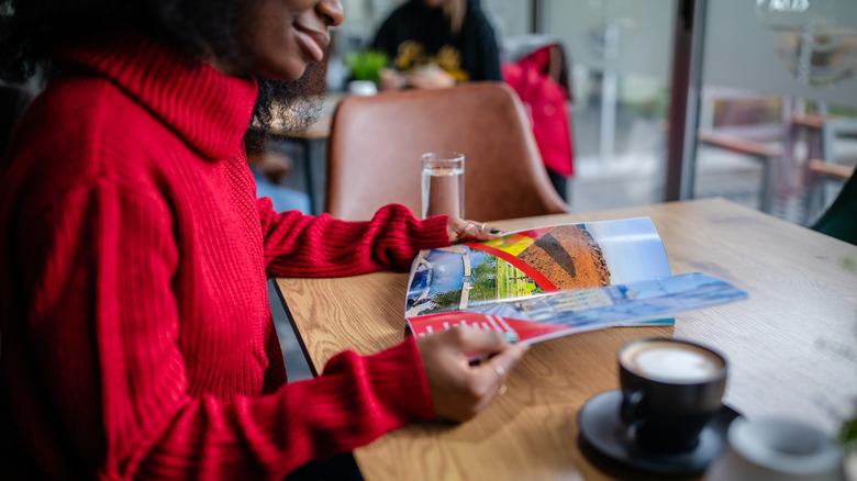 A woman reading a travel magazine
