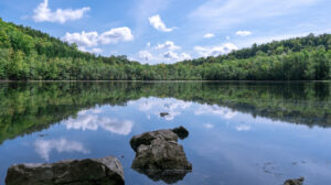 New York's Serene State Park Boasts A Glassy Plunge Pool Lake With Rugged Trails And Fall Colors

